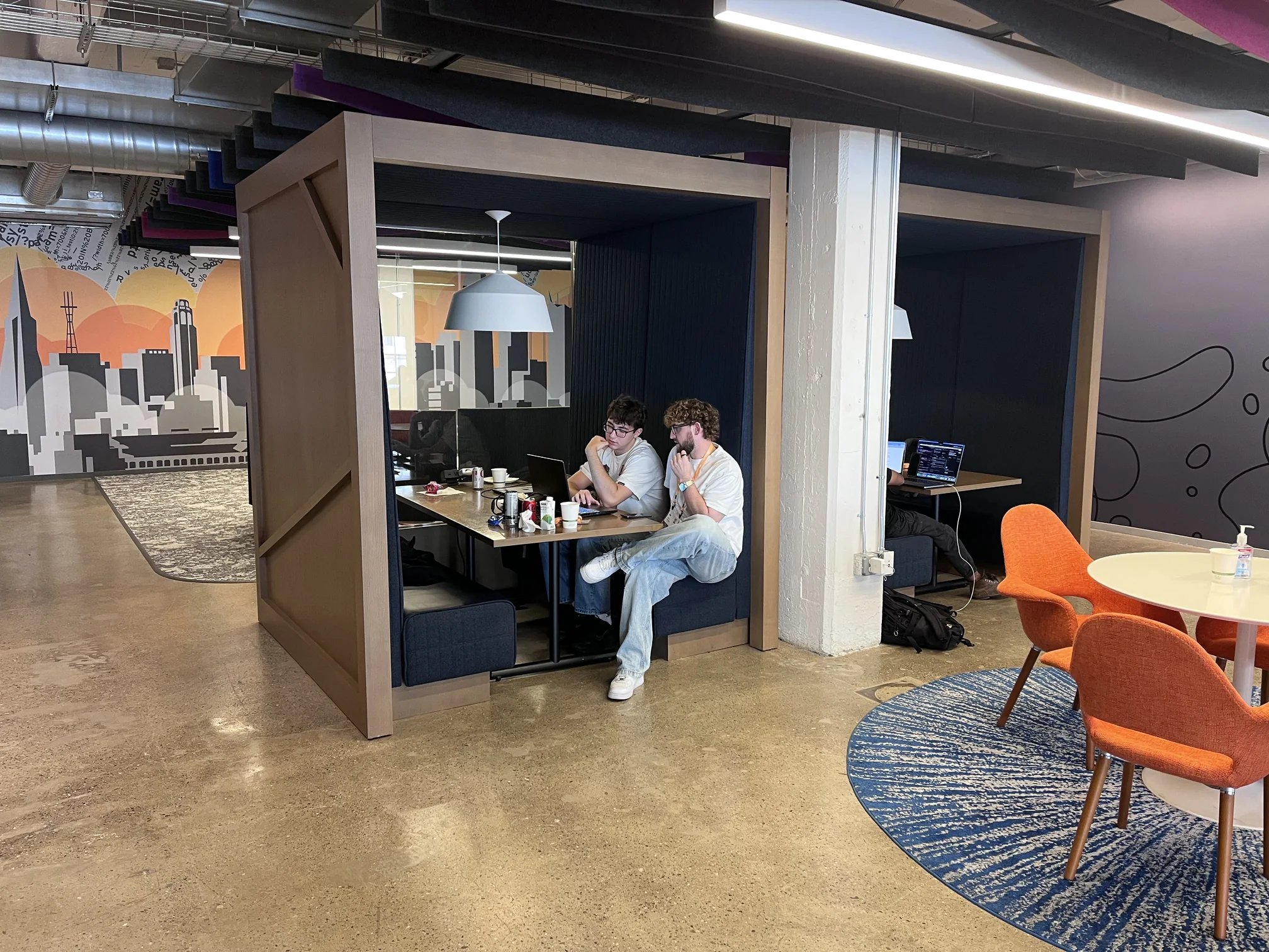 A team working in one of the office booths