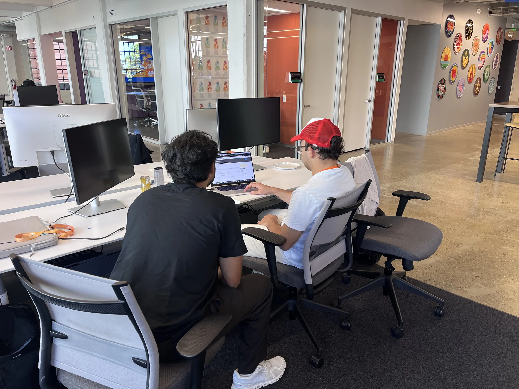 Two builders at a desk mid-build